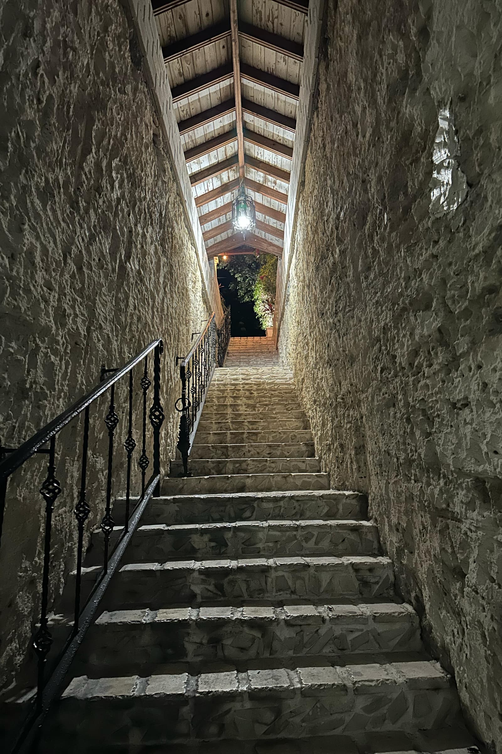 The old cut-limestone staircase rising through a narrow passage in the rock to the house above